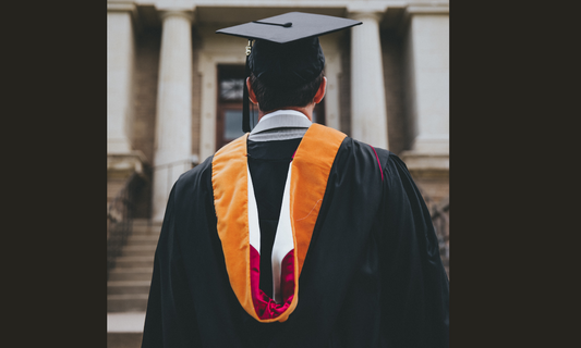 Do you wear a suit jacket under graduation gown?